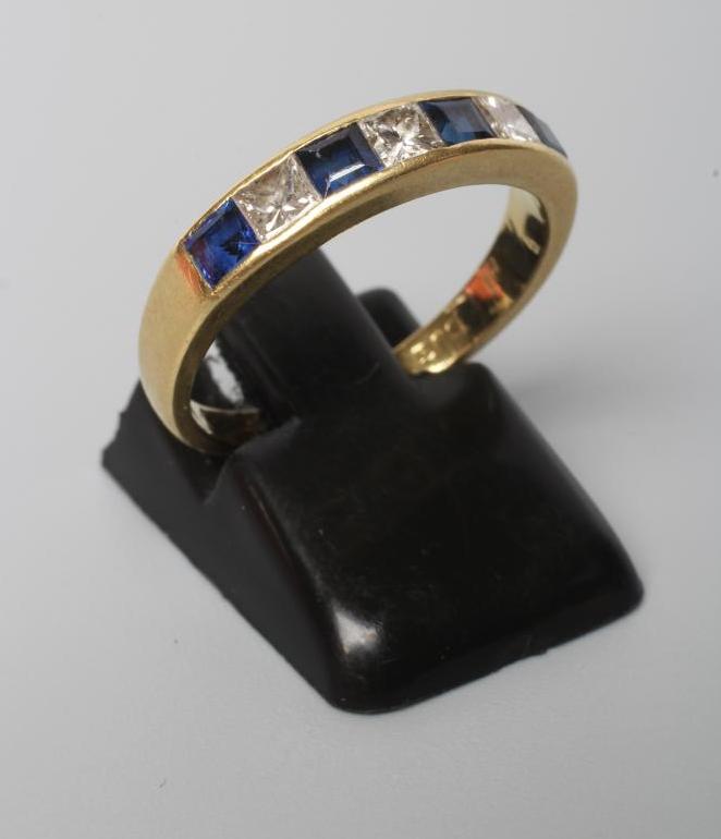 A SAPPHIRE AND DIAMOND HALF HOOP ETERNITY RING Image