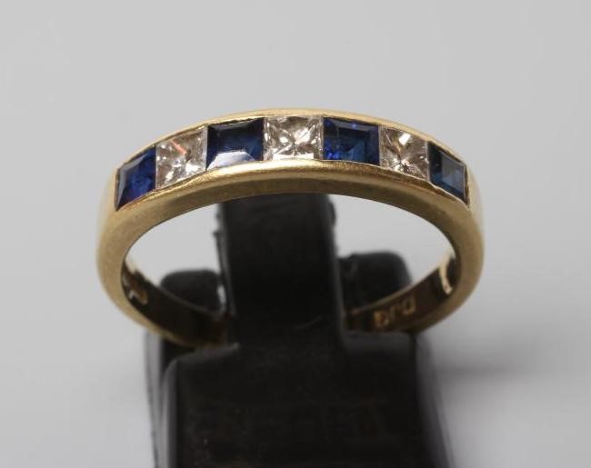 A SAPPHIRE AND DIAMOND HALF HOOP ETERNITY RING Image
