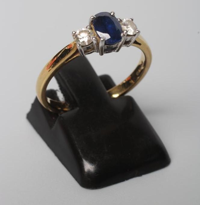 A SAPPHIRE AND DIAMOND THREE STONE RING Image