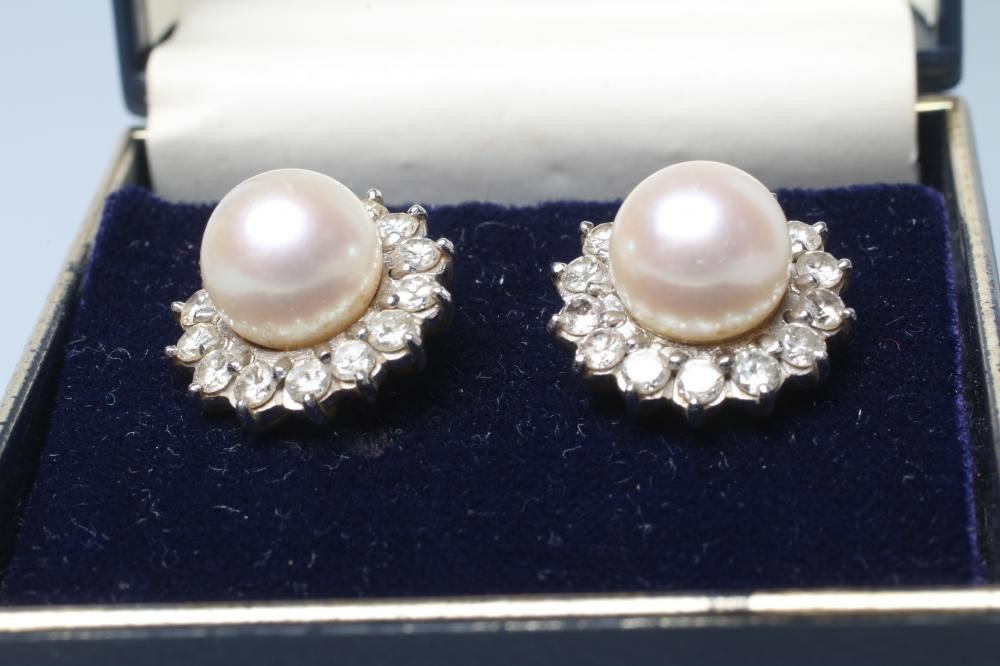 A PAIR OF PEARL AND DIAMOND CLUSTER EAR STUDS Image