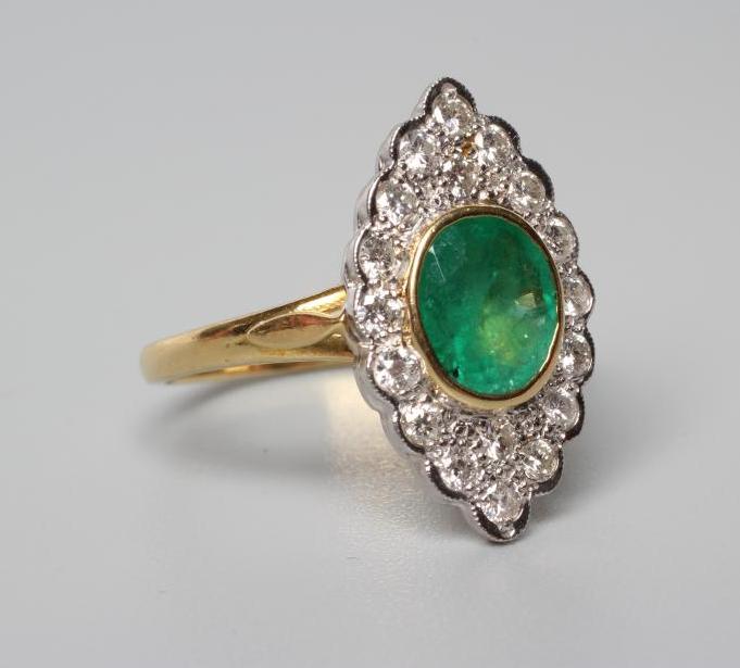 AN EMERALD AND DIAMOND CLUSTER RING Image