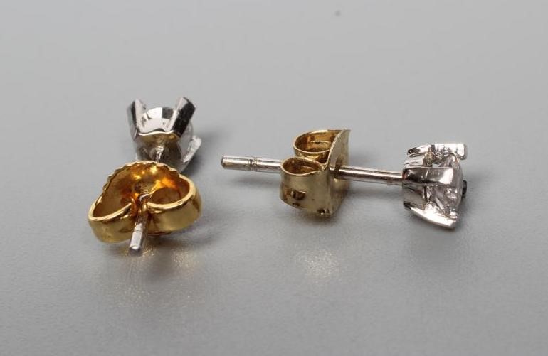 A PAIR OF DIAMOND SOLITAIRE EAR STUDS Image