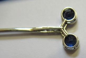 A CARTIER SAPPHIRE AND DIAMOND STICK PIN by Henri Droguet Image