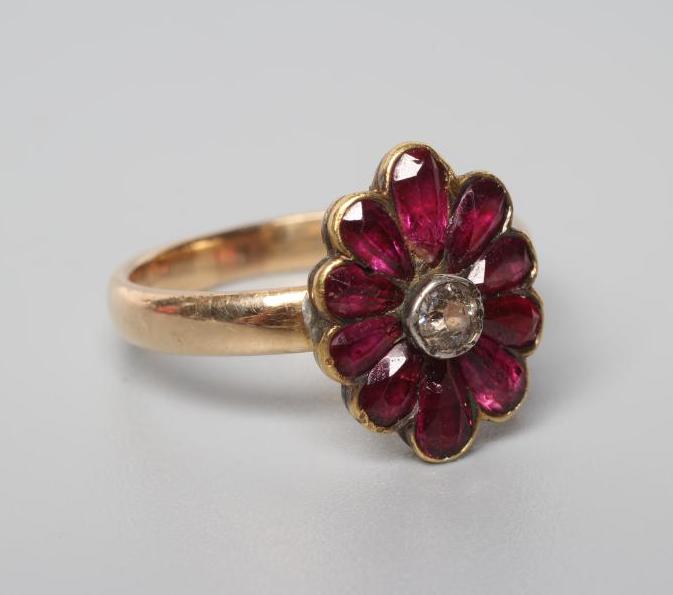 A VICTORIAN GARNET AND DIAMOND CLUSTER RING Image