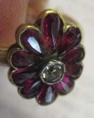 A VICTORIAN GARNET AND DIAMOND CLUSTER RING Image