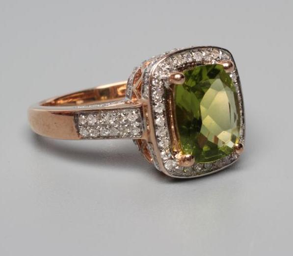 A PERIDOT AND DIAMOND CLUSTER DRESS RING Image