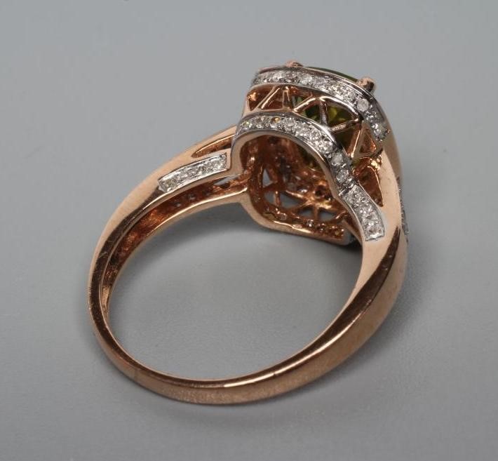 A PERIDOT AND DIAMOND CLUSTER DRESS RING Image