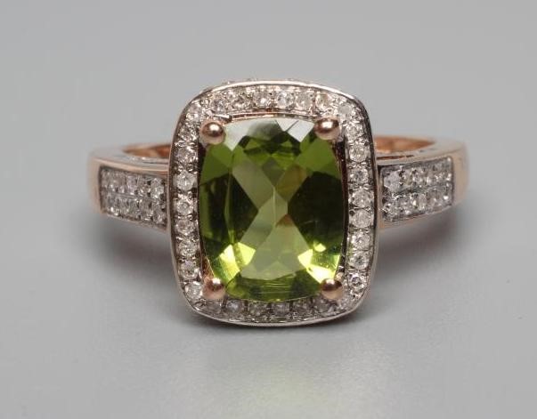 A PERIDOT AND DIAMOND CLUSTER DRESS RING Image