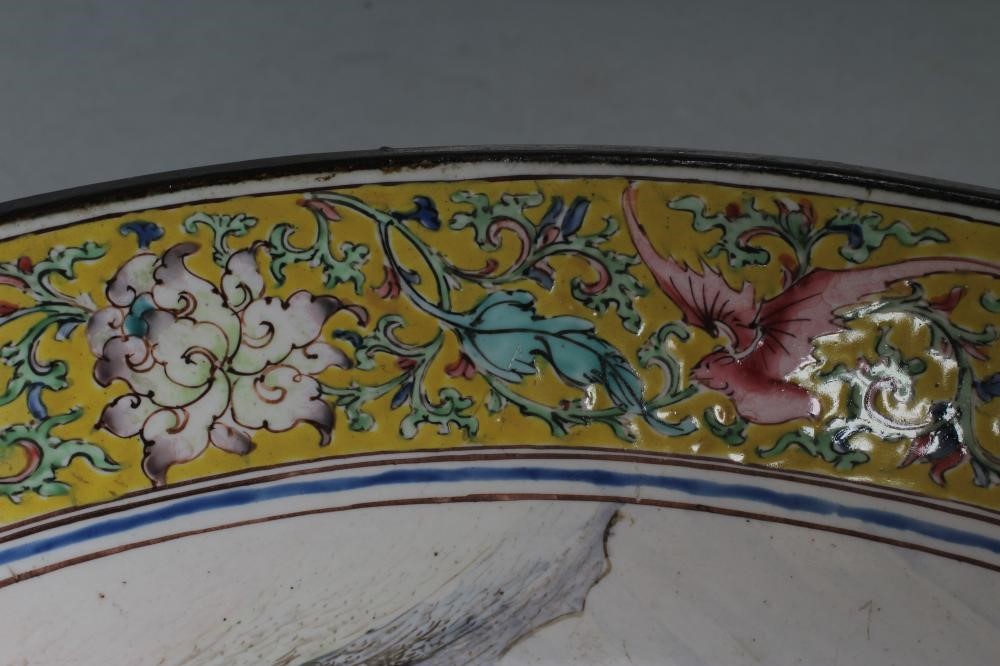 A PAIR OF CANTON ENAMEL SAUCER DISHES centrally painted in pastel colours with figures in extensive Image