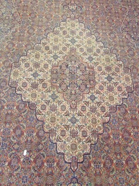 A PERSIAN TABRIZ CARPET Image