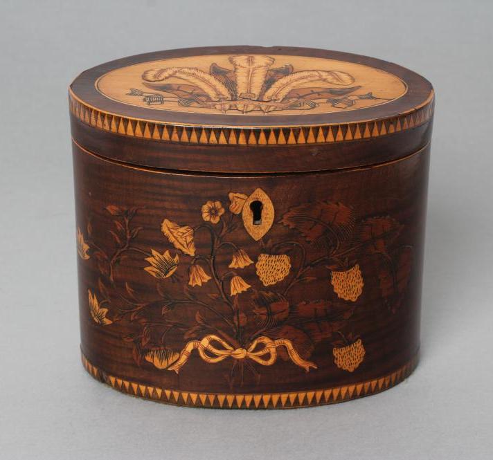 A REGENCY MAHOGANY TEA CADDY of oval form with ribbon tied marquetry flowers and berried branches Image