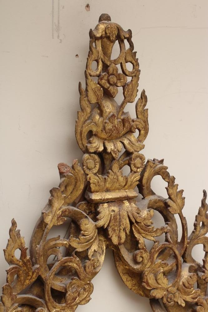 A CARVED AND GILT WOOD INDIAN FRAME of arched oblong form Image