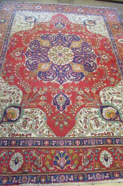 A PERSIAN WOOL RUG Image