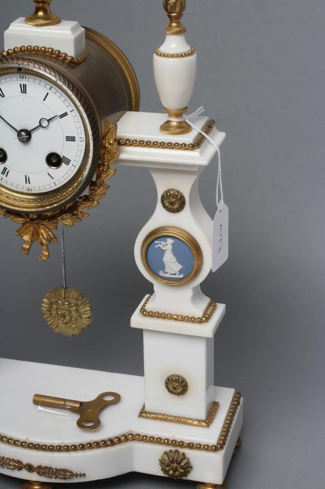 A FRENCH WHITE MARBLE AND GILT METAL PORTICO CLOCK Image