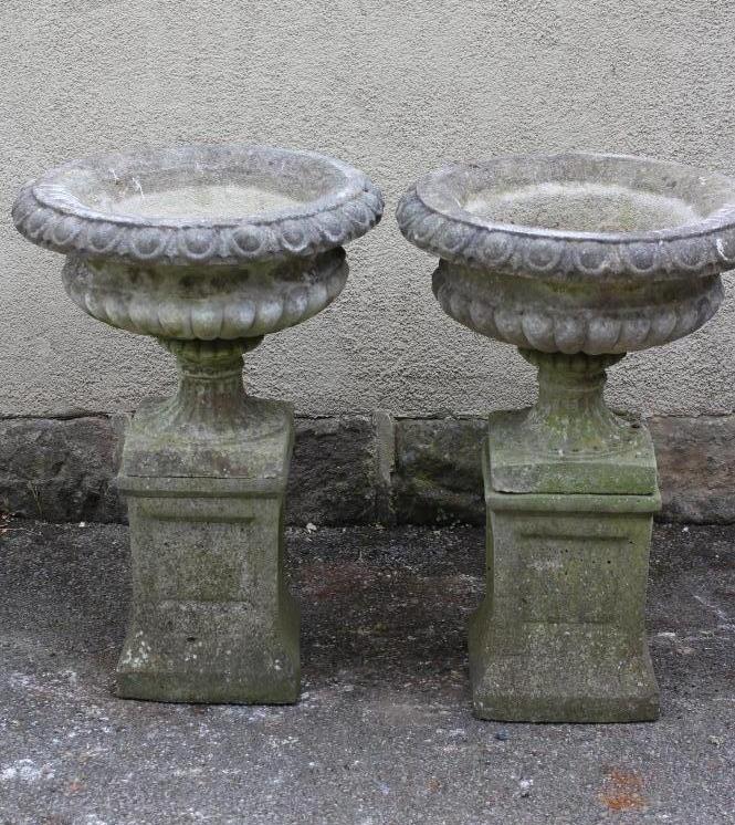 A PAIR OF HADDONSTONE STONE URNS of half fluted campana form with egg and dart rim Image