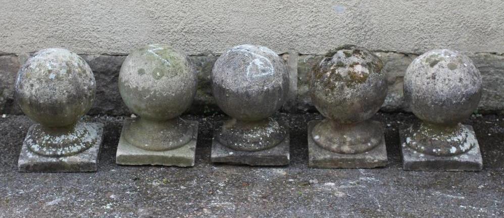 A SET OF FIVE COMPOSITION STONE BALL FINIALS on square bases Image