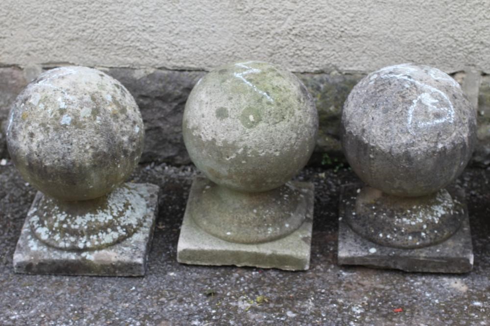 A SET OF FIVE COMPOSITION STONE BALL FINIALS on square bases Image