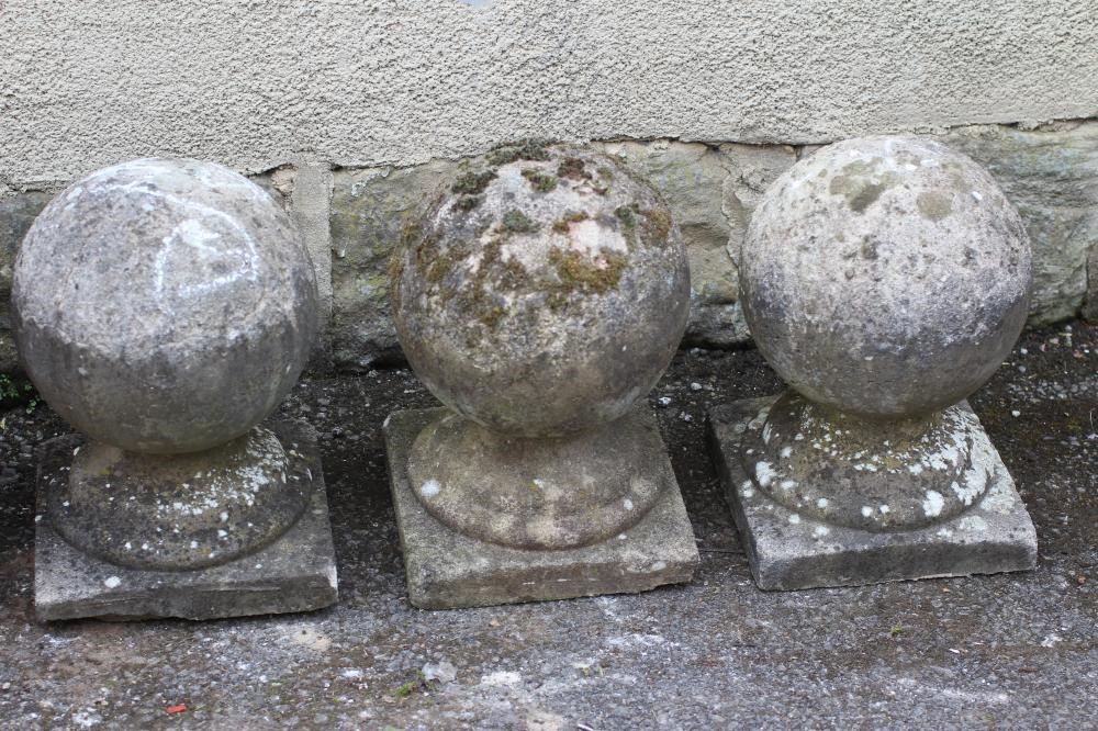 A SET OF FIVE COMPOSITION STONE BALL FINIALS on square bases Image