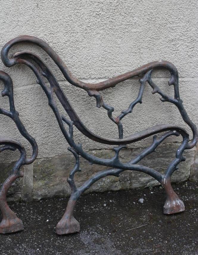 A PAIR OF VICTORIAN CAST IRON PARK BENCH ENDS of truncated branch form Image