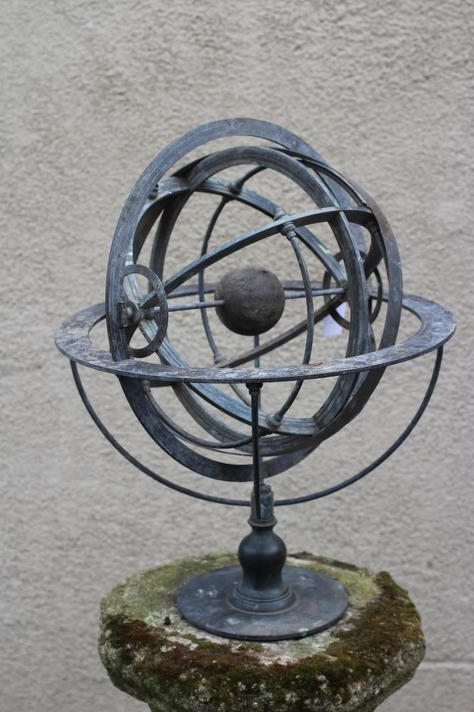 A BRONZED METAL ARMILLARY SPHERE on turned baluster stem and circular base Image