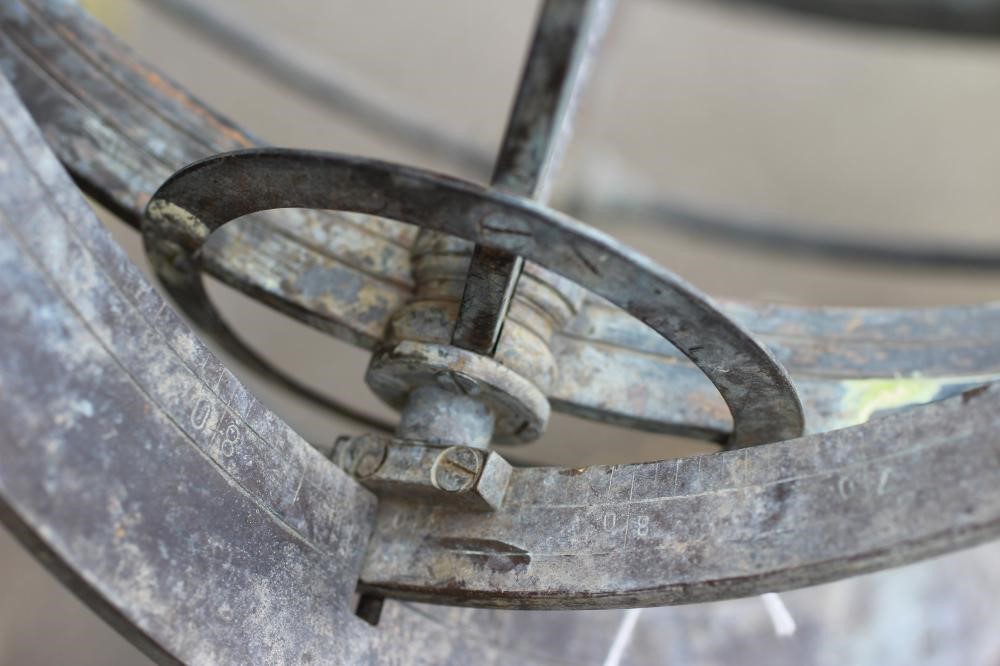 A BRONZED METAL ARMILLARY SPHERE on turned baluster stem and circular base Image