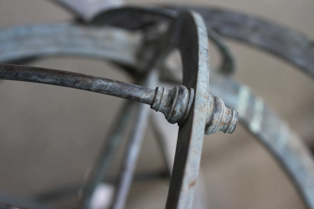 A BRONZED METAL ARMILLARY SPHERE on turned baluster stem and circular base Image