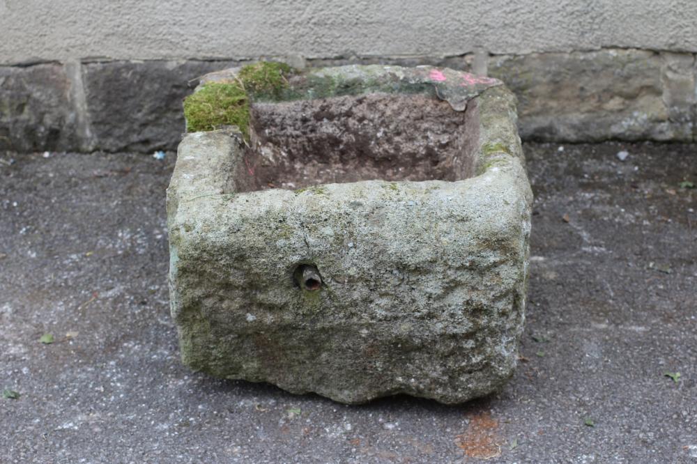 A GRITSTONE TROUGH of rough hewn square form Image