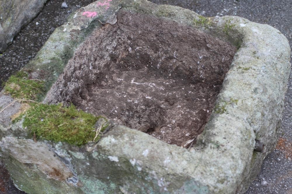 A GRITSTONE TROUGH of rough hewn square form Image