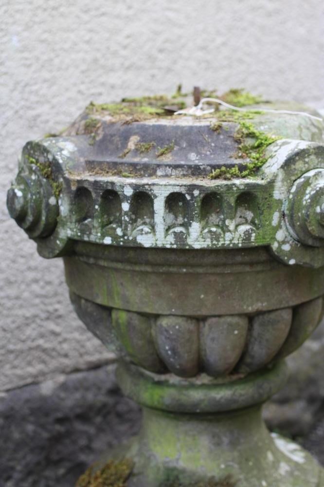 A SANDSTONE STAND of vase form with lobed banding Image