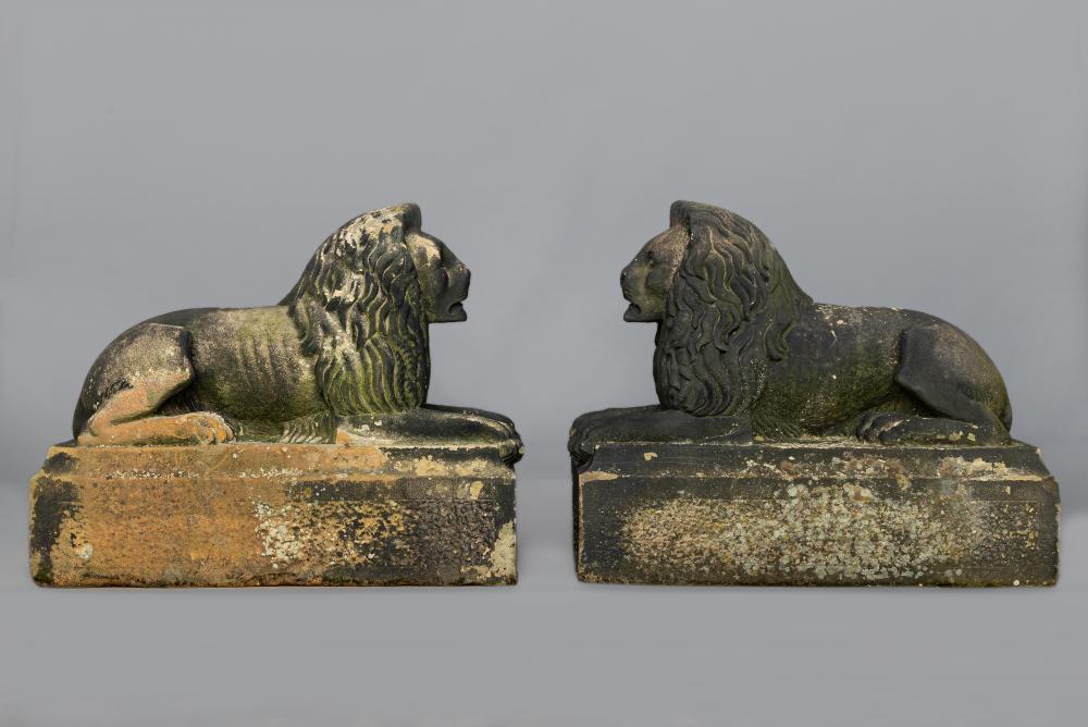 A PAIR OF CARVED STONE RECUMBENT LIONS Image