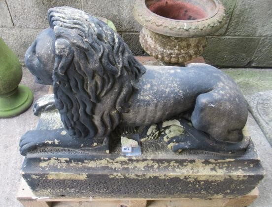 A PAIR OF CARVED STONE RECUMBENT LIONS Image