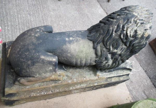 A PAIR OF CARVED STONE RECUMBENT LIONS Image