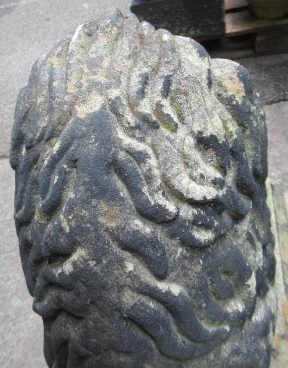 A PAIR OF CARVED STONE RECUMBENT LIONS Image