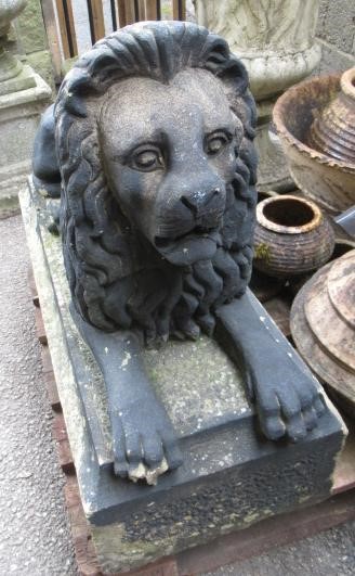 A PAIR OF CARVED STONE RECUMBENT LIONS Image