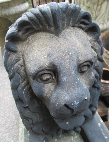 A PAIR OF CARVED STONE RECUMBENT LIONS Image