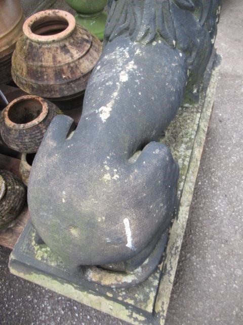 A PAIR OF CARVED STONE RECUMBENT LIONS Image