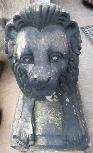 A PAIR OF CARVED STONE RECUMBENT LIONS Image
