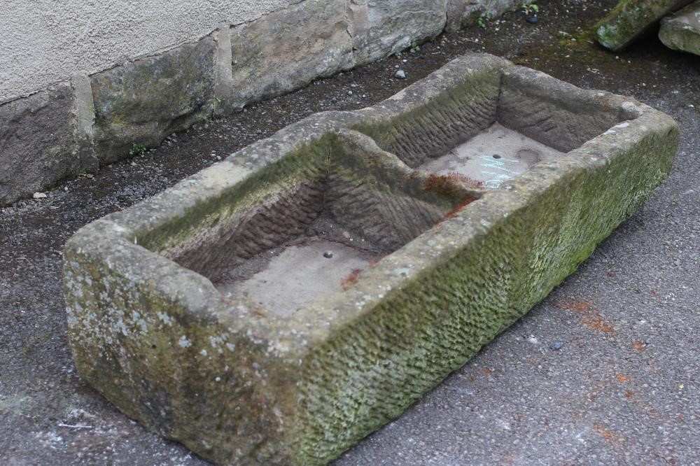 A SANDSTONE TROUGH of fine cut narrow oblong form with central division Image