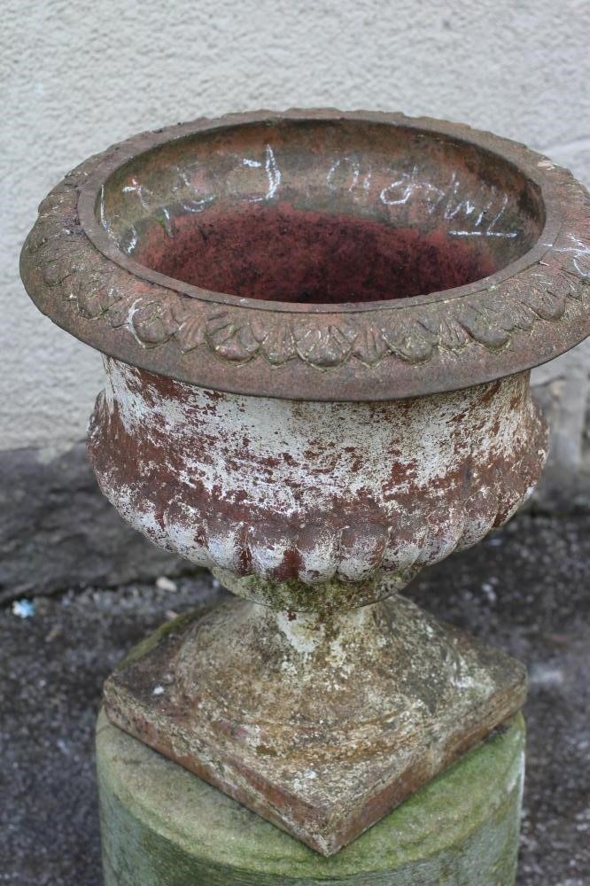 A VICTORIAN TERRACOTTA GARDEN URN of half fluted campana form with leaf moulded rim Image