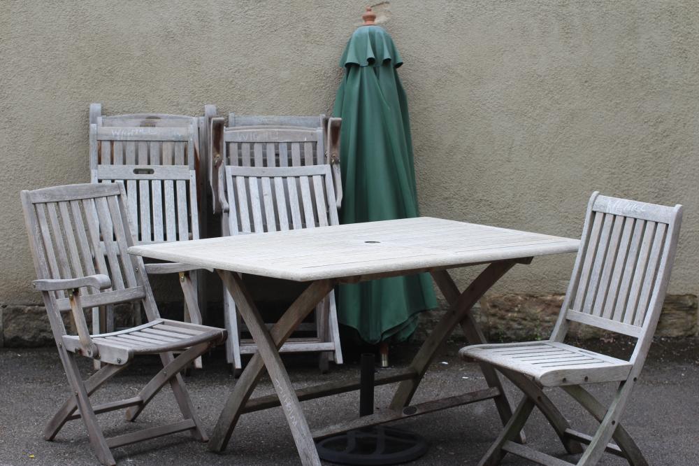 A SLATTED TEAK DINING SUITE Image