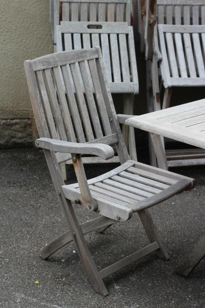 A SLATTED TEAK DINING SUITE Image