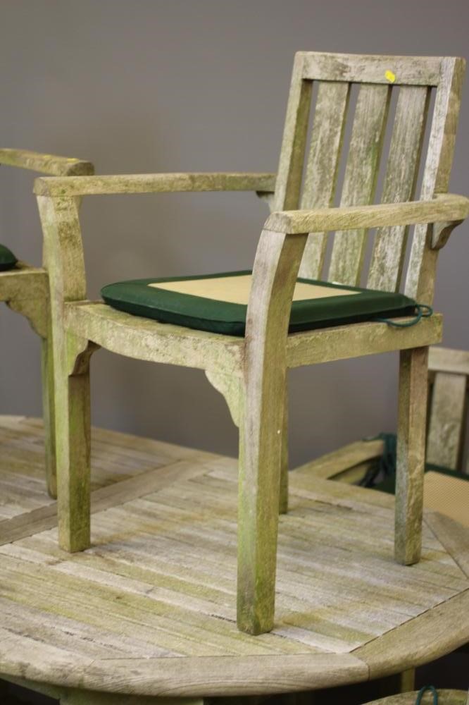 A SLATTED TEAK DINING SUITE comprising an extending dining table of D ended form with central Image