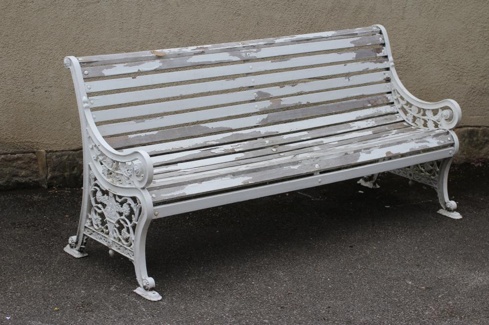 A VICTORIAN CAST IRON PARK BENCH with slatted wood seat and back Image