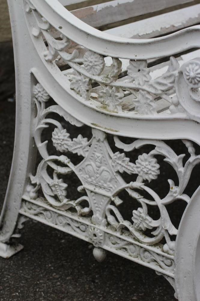 A VICTORIAN CAST IRON PARK BENCH with slatted wood seat and back Image
