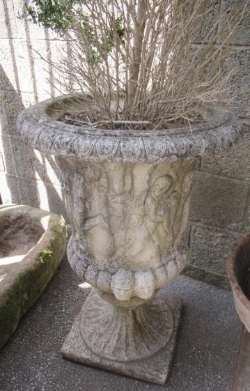 A PAIR OF MEDICI PATTERN COMPOSITION STONE URNS with flared egg and dart rim over a frieze of Image