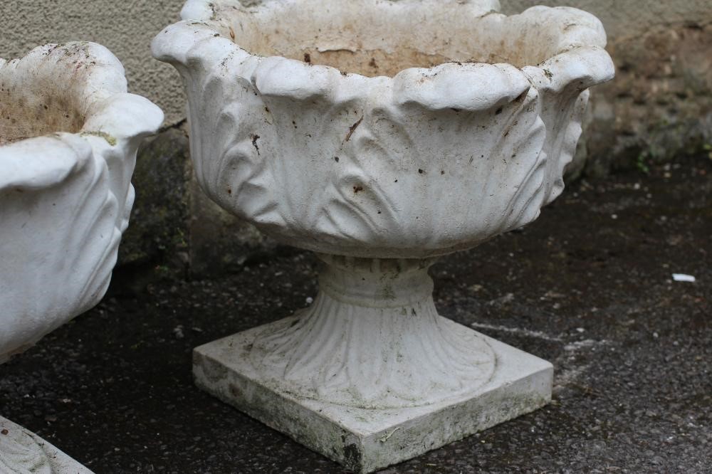 A PAIR OF COMPOSITION STONE URNS Image