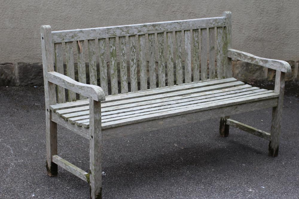 A TEAK SLATTED GARDEN BENCH with straight top rail Image