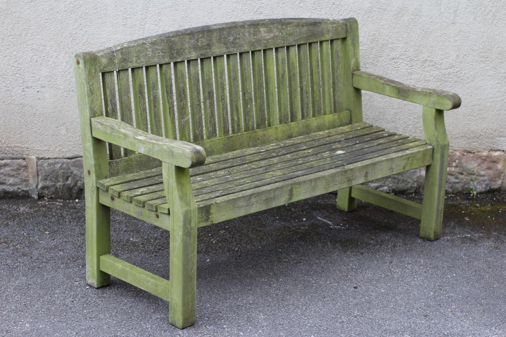A TEAK SLATTED GARDEN BENCH with arched back Image