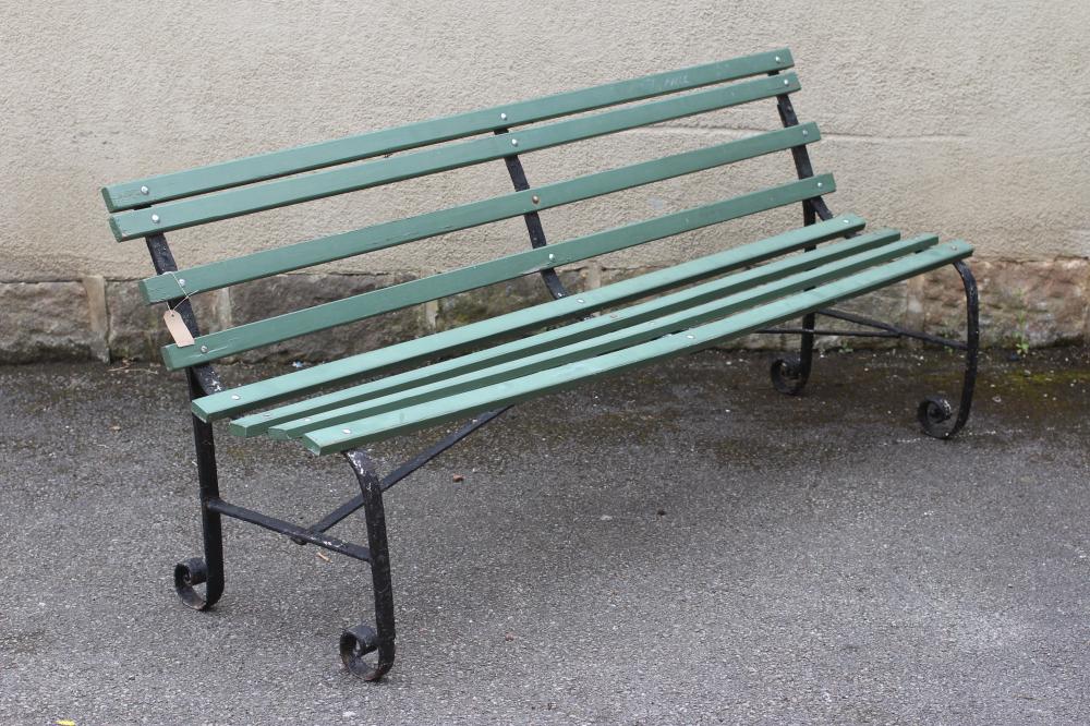 A VICTORIAN WROUGHT IRON STRAPWORK BENCH with slatted wood seat and back Image