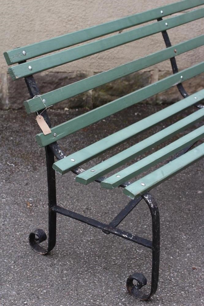 A VICTORIAN WROUGHT IRON STRAPWORK BENCH with slatted wood seat and back Image